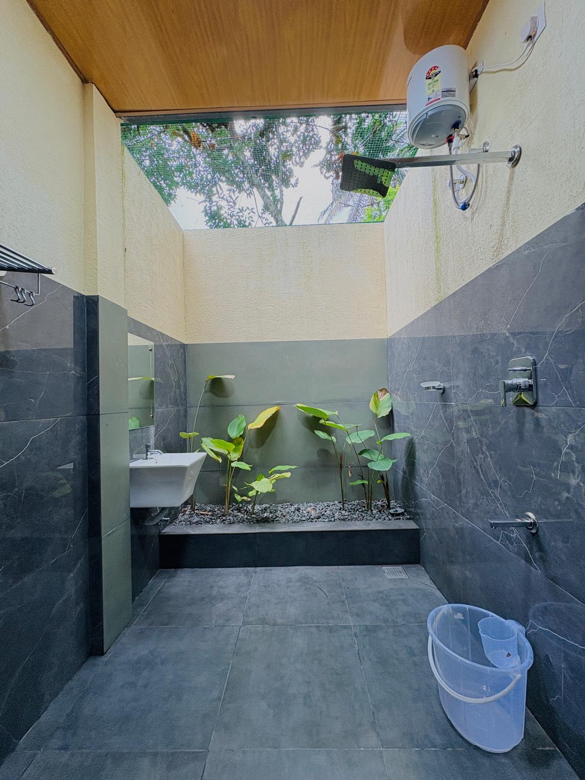 Luxury suite at JKR Gardens Resort featuring spacious seating area, contemporary furnishings, and natural light